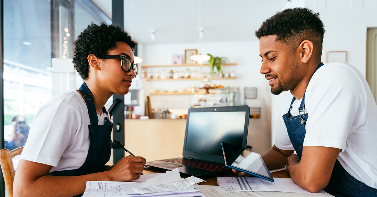 two people reviewing business financials 