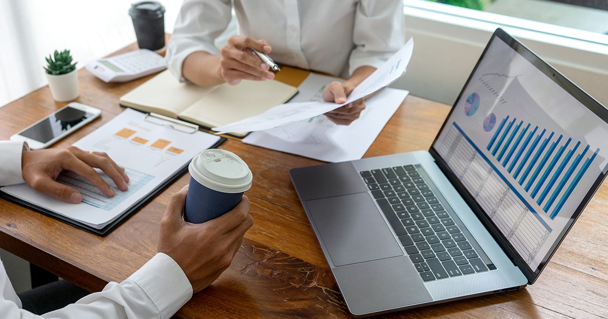 people reviewing business documents at table