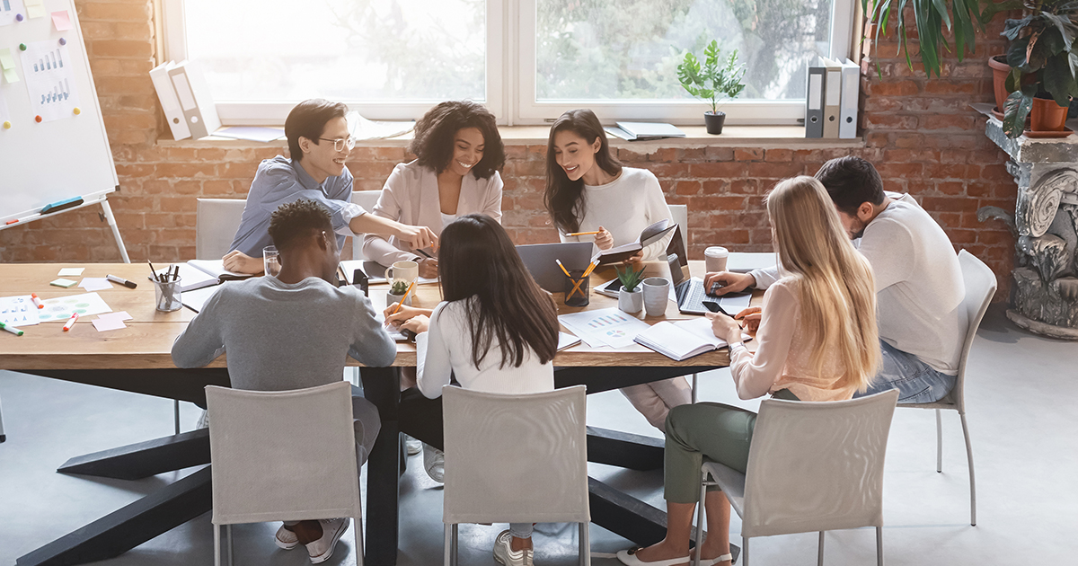 people working at a table in a group