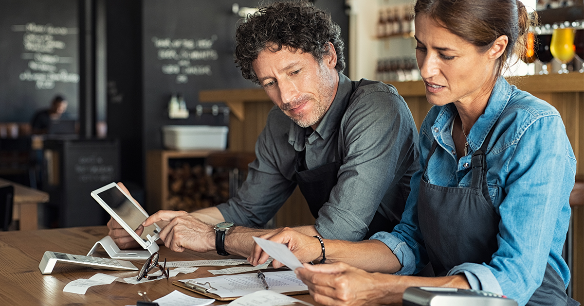 two people looking at business expenses