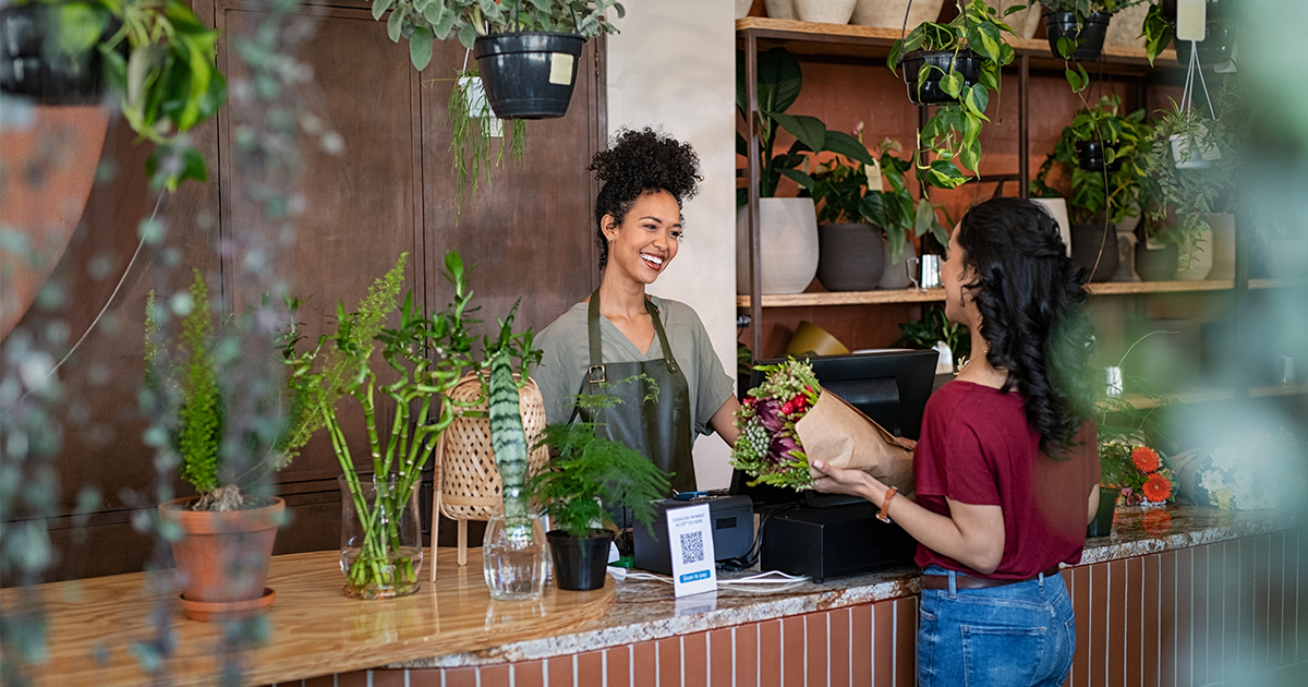 woman helping customer at flower shop