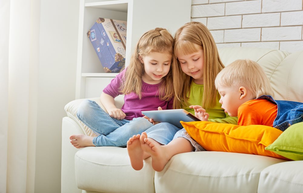 Kids sitting together on couch