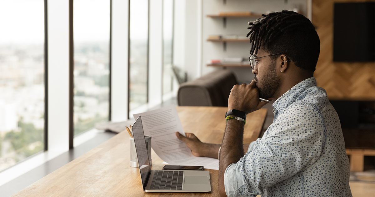 person reviewing document at desk