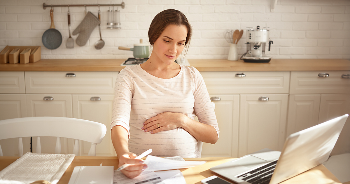 pregnant woman reviewing paperwork