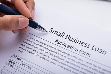 hand filling out a small business loan application